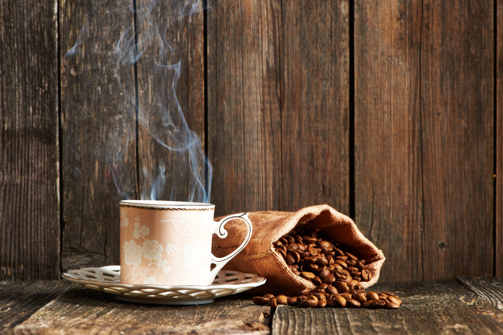 Hot cup of coffee with coffee beans